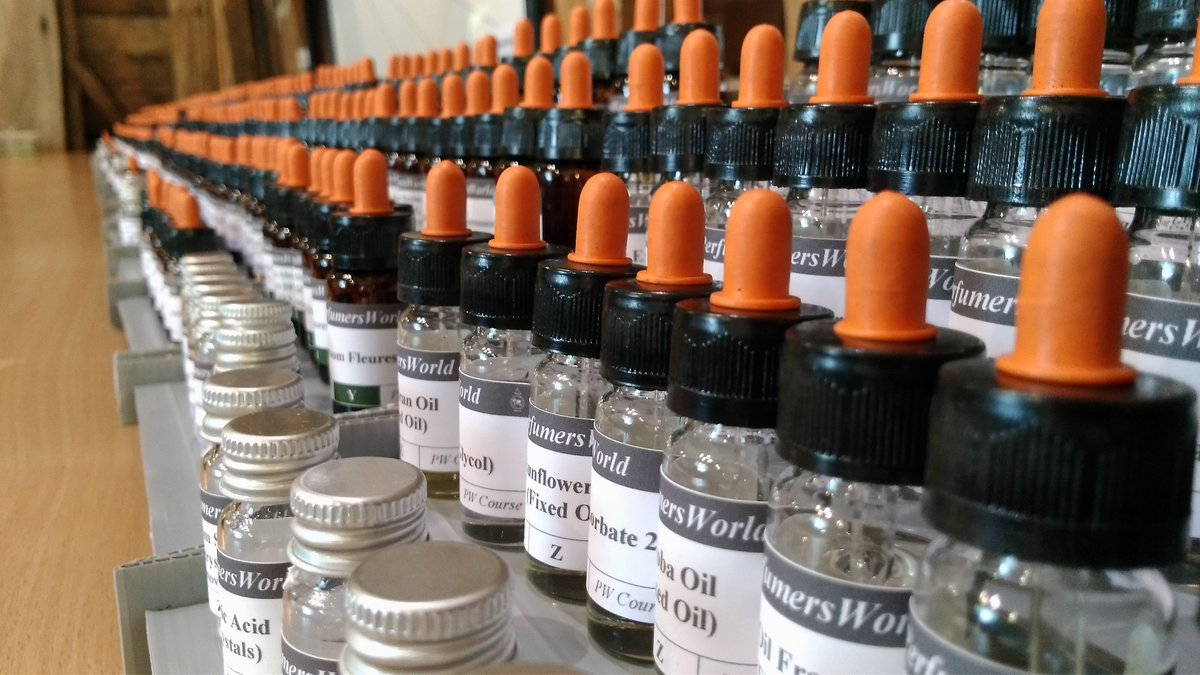 Rows of labelled PerfumersWorld raw material bottles