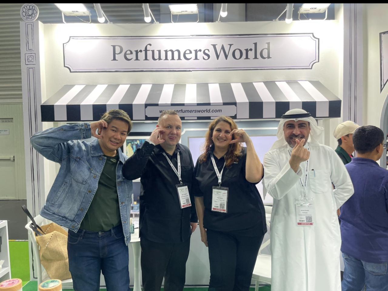 A group gathered at a PerfumersWorld exhibition stand